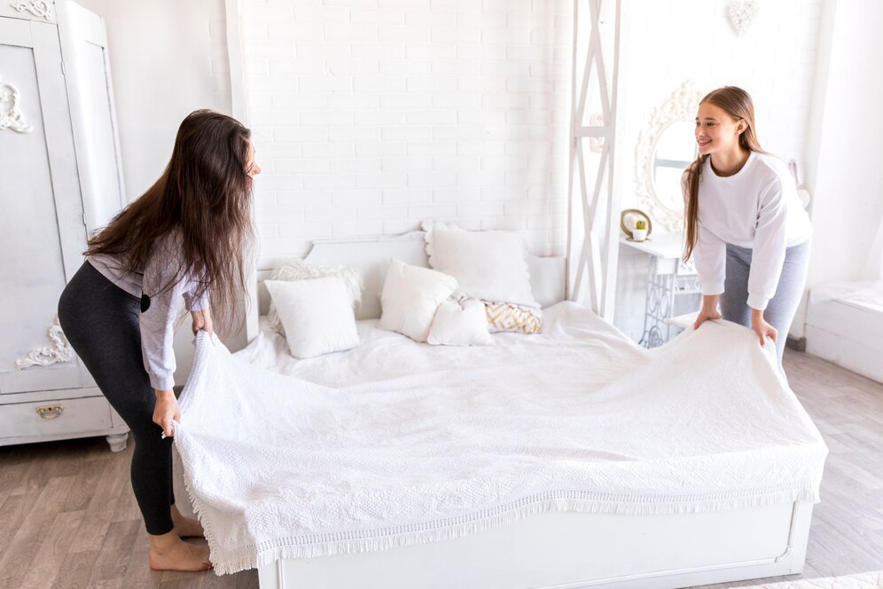 smiley-women-making-bed_23-2148227401
